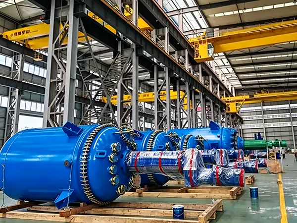 Row of massive blue glass-lined reactors wrapped in protective film ready for international sea freight delivery