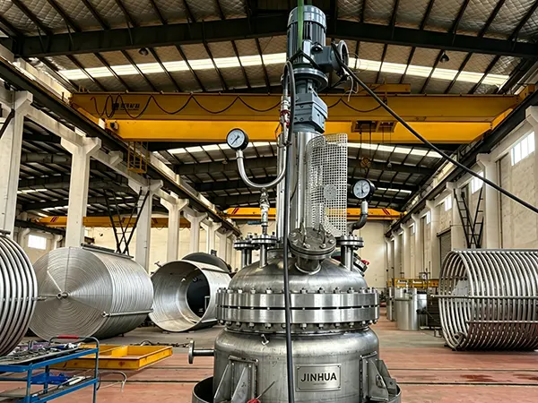 Jinhua technicians performing mechanical test runs and pressure checking on a heavy-duty customized Titanium reactor vessel surrounded by factory coils.